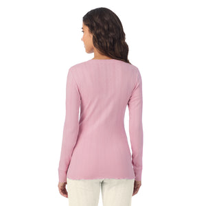 A lady is wearing Cotton Pointelle Long Sleeve Henley
