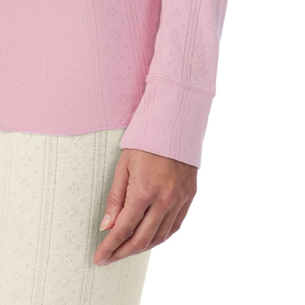 A lady is wearing Cotton Pointelle Long Sleeve Henley
