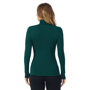 A lady wearing dk pine/navy stripe long sleeve turtleneck softwear with stretch top.