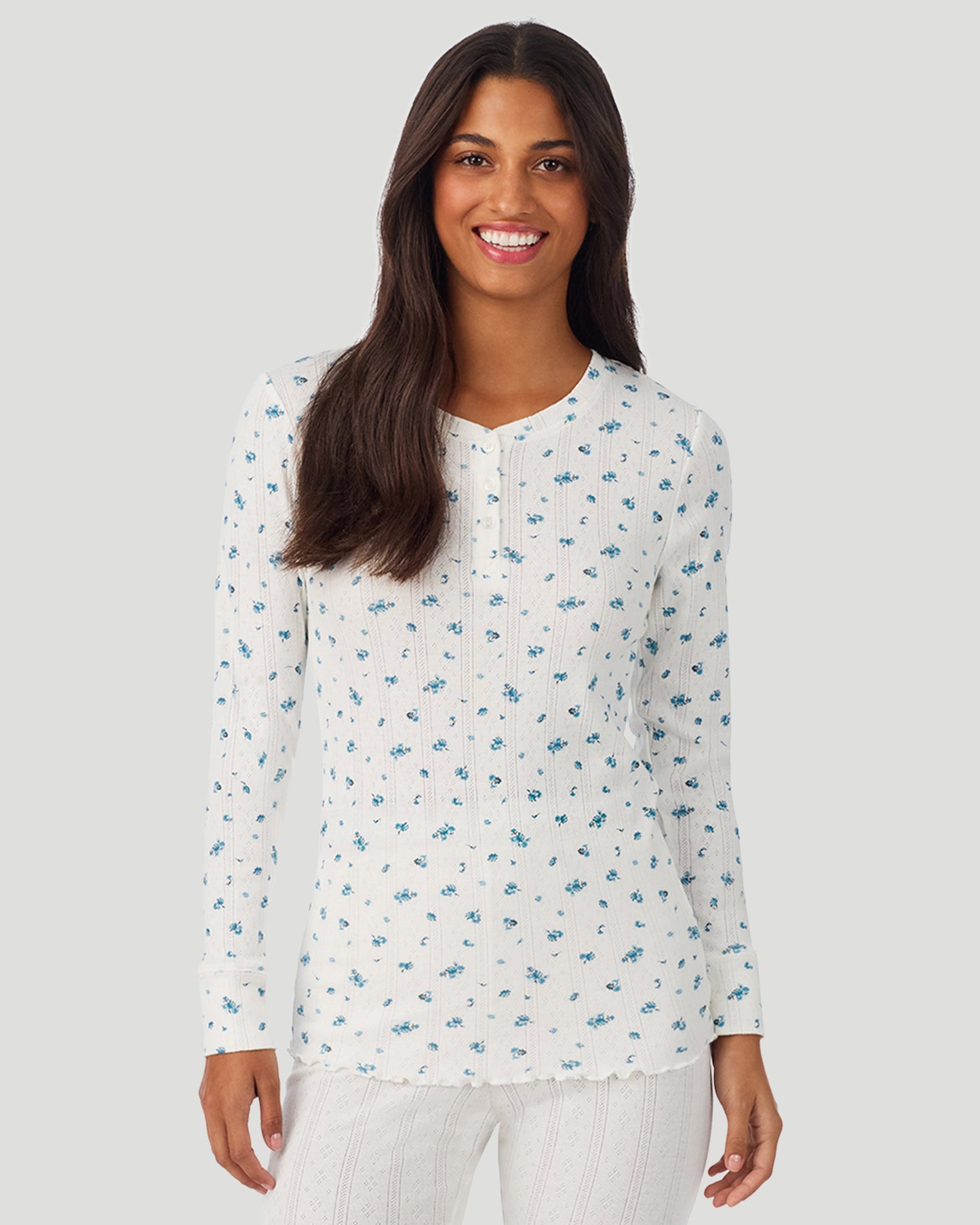 Blue Ditsy; Model is wearing a size S. She is 5’7”, Bust 32”, Waist 25”, Hips 34”. @A lady is wearing Blue Ditsy Cotton Pointelle Long Sleeve Henley in a front view look
