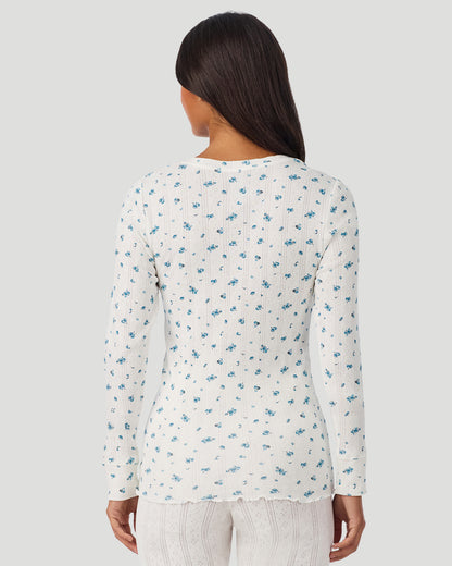 A lady is wearing Blue Ditsy Cotton Pointelle Long Sleeve Henley in a back view look
