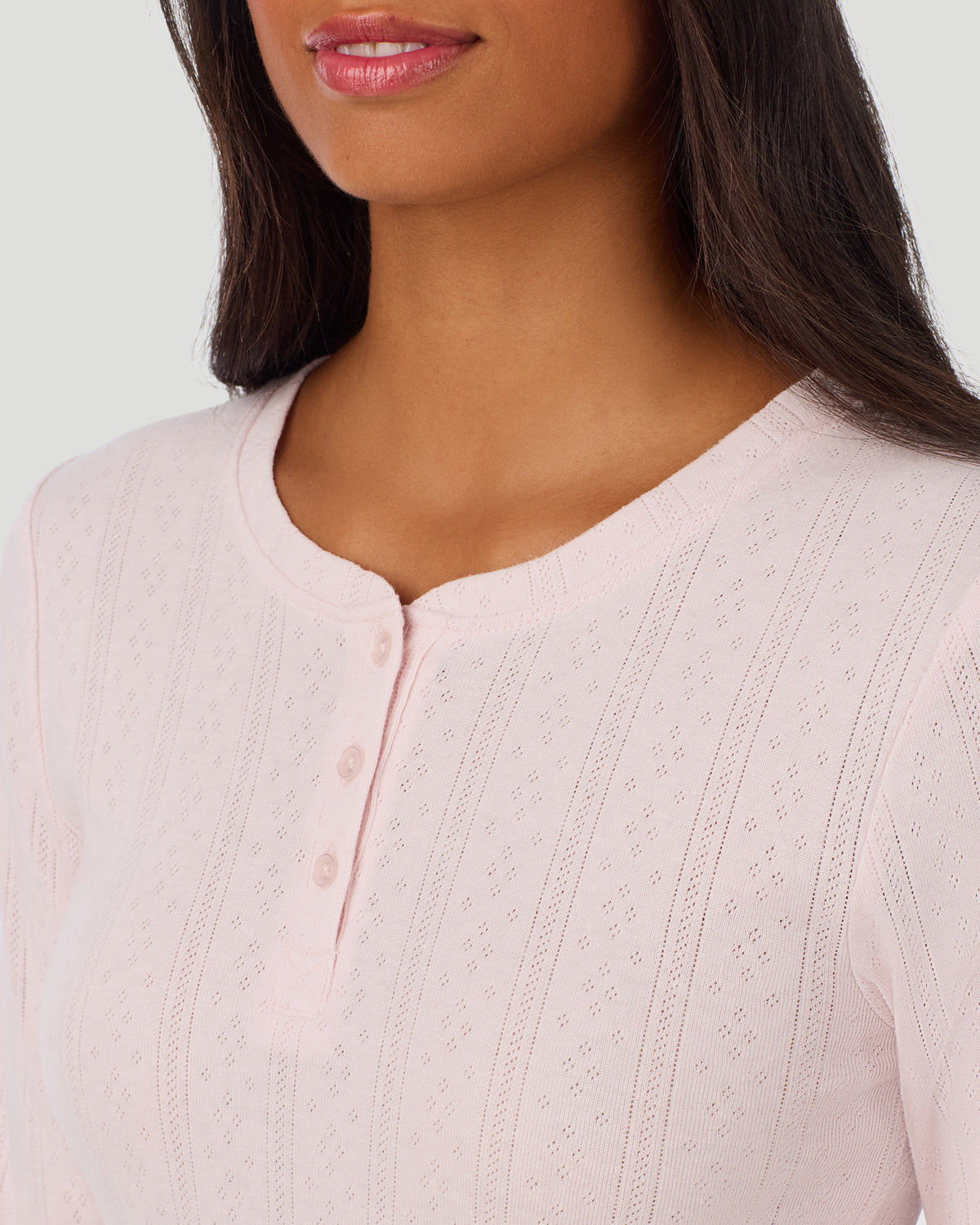 A lady is wearing Pretty Rose Cotton Pointelle Long Sleeve Henley in a front view detail close up look