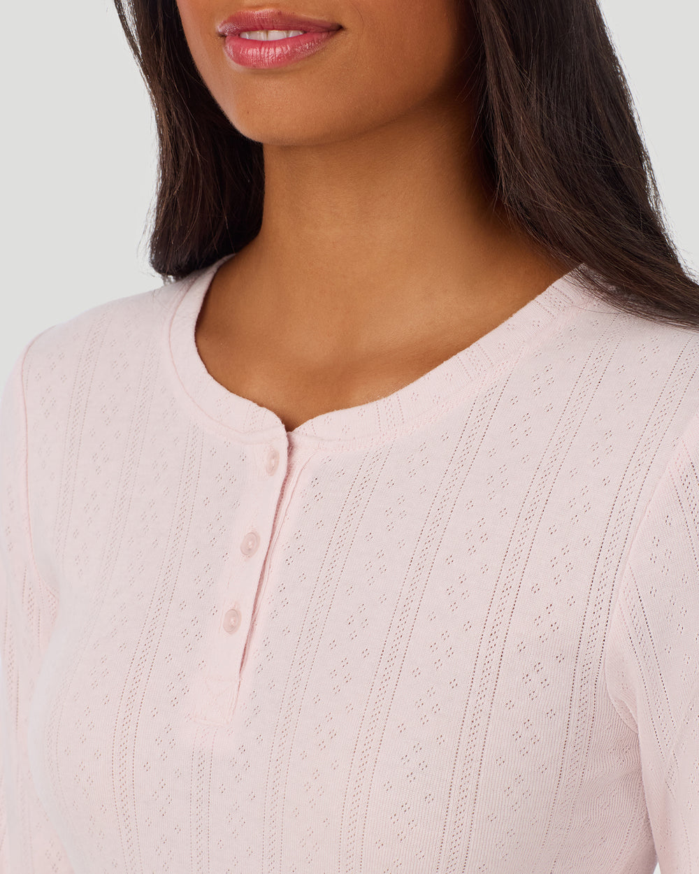 A lady is wearing Pretty Rose Cotton Pointelle Long Sleeve Henley in a front view detail close up look