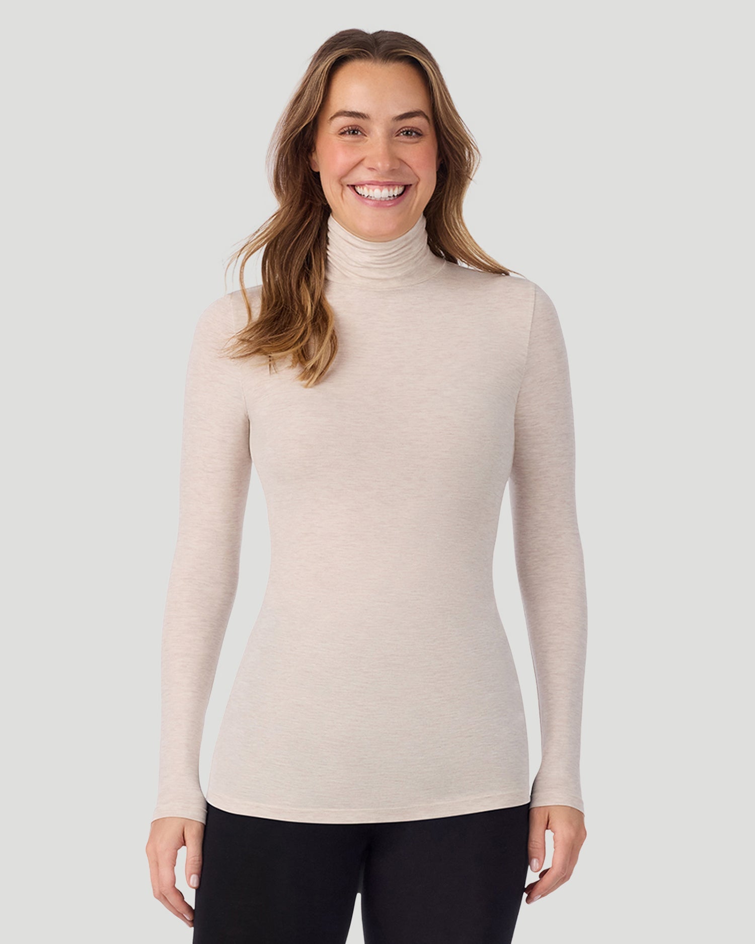 A lady wearing Oatmeal Heather Softwear With Stretch Long Sleeve Turtleneck top in a front pose