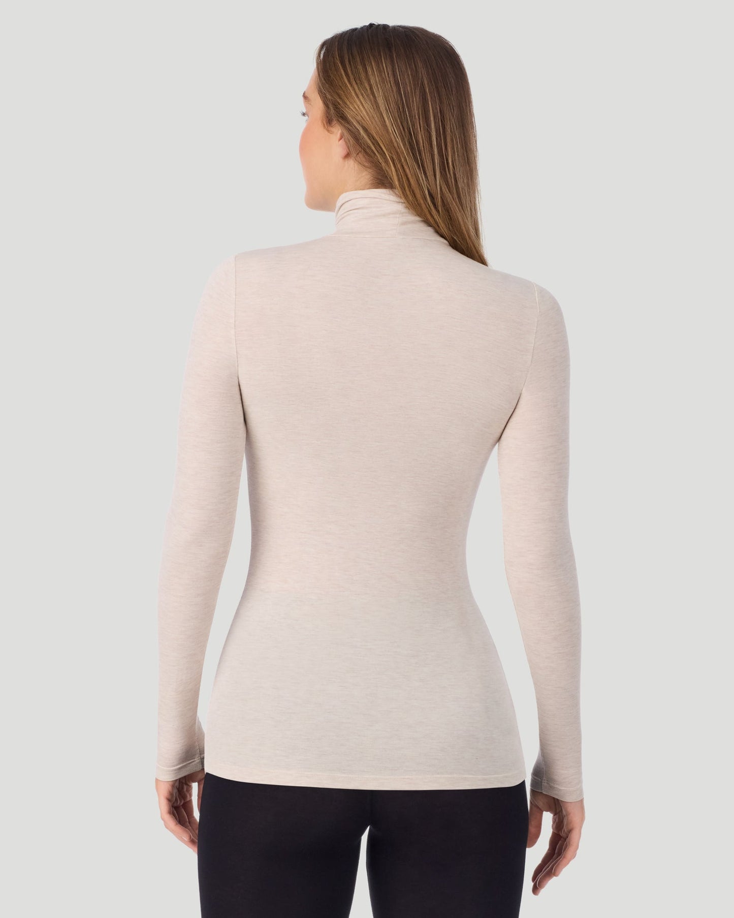 Oatmeal Heather; Model is wearing a size S. She is 5’11.5”, Bust 34”, Waist 27”, Hips 38.5”. @A lady wearing Oatmeal Heather Softwear With Stretch Long Sleeve Turtleneck top in a back pose