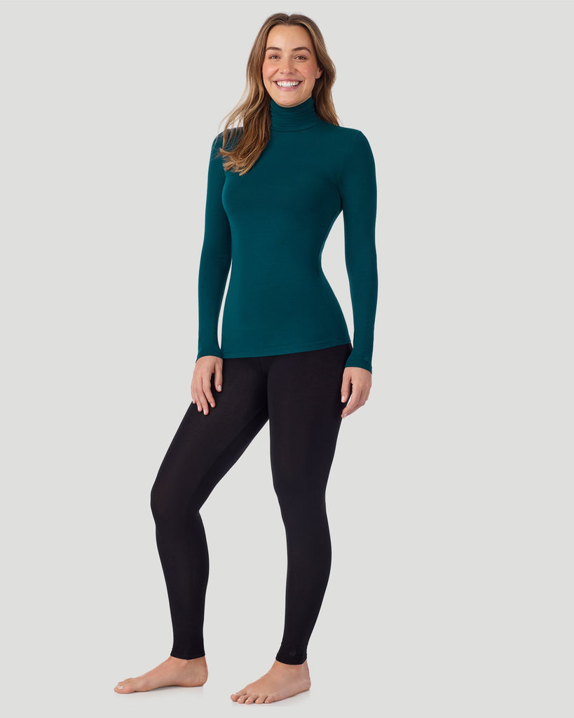 A lady wearing Deep Emerald Softwear With Stretch Long Sleeve Turtleneck top in a front standing pose