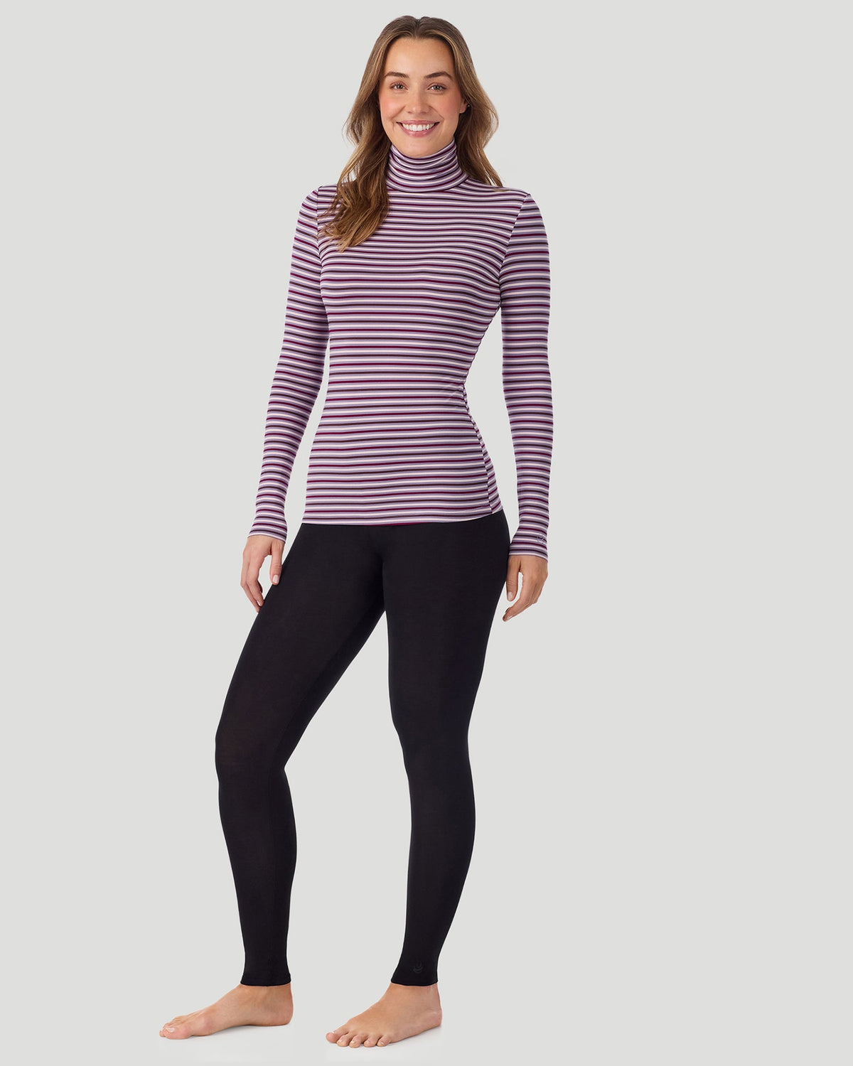 Lilac Stripe; Model is wearing a size S. She is 5’11.5”, Bust 34”, Waist 27”, Hips 38.5”. @A lady wearing Lilac Stripe Softwear With Stretch Long Sleeve Turtleneck top in a front standing pose