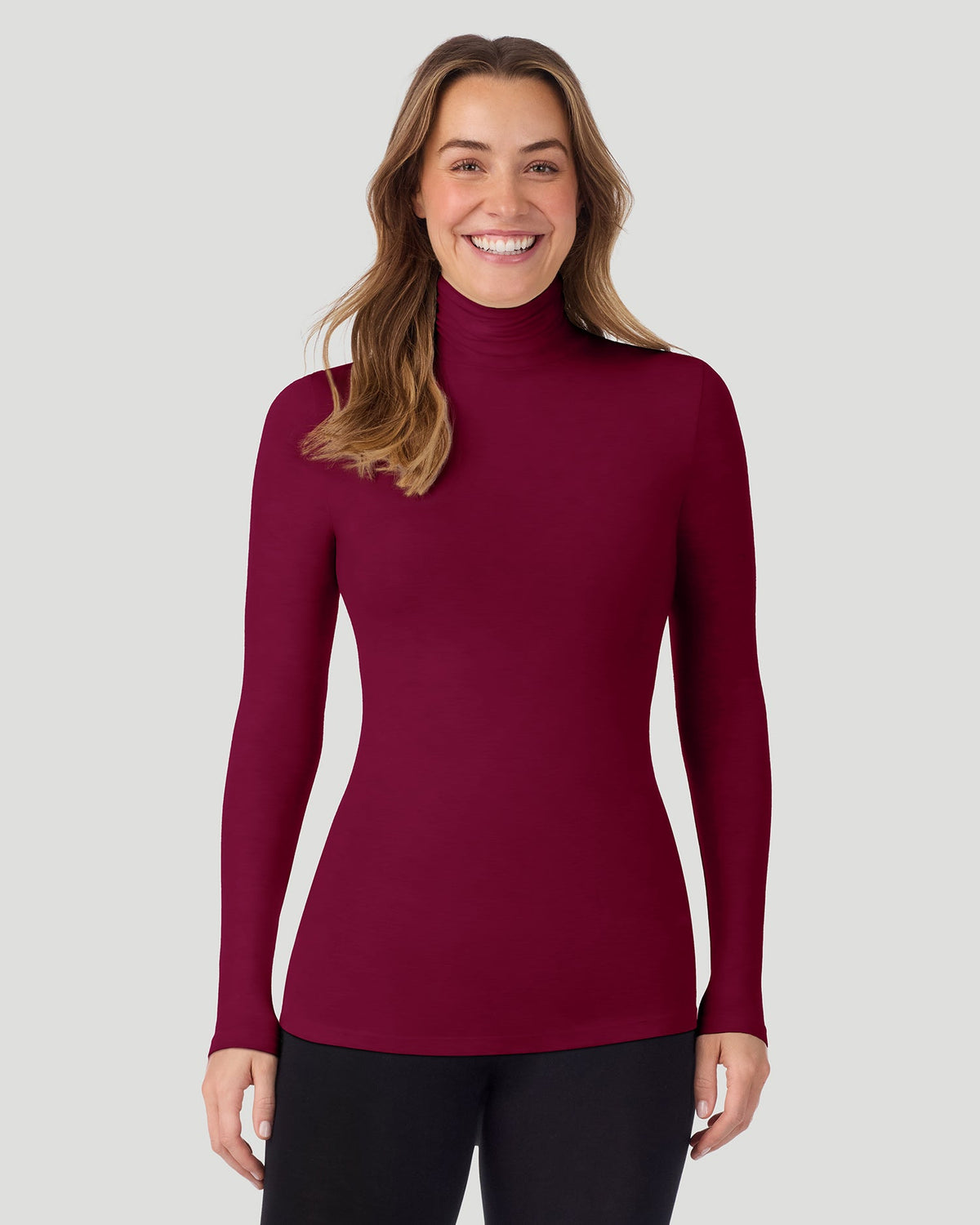 Scarlet; Model is wearing a size S. She is 5’11.5”, Bust 34”, Waist 27”, Hips 38.5”. @A lady wearing Scarlet Softwear With Stretch Long Sleeve Turtleneck top in a front pose