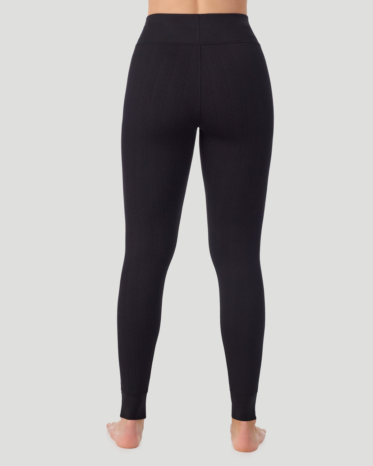 Black; Model is wearing a size S. She is 5’11.5”, Bust 34”, Waist 27”, Hips 38.5”. @ A lady wearing Cozy Cable Legging in black posing back view standing shot