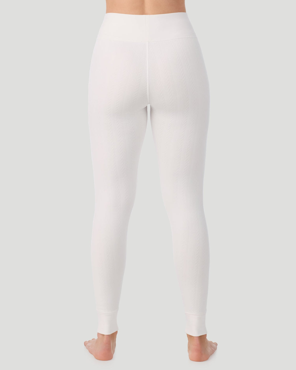 Ivory; Model is wearing a size S. She is 5’11.5”, Bust 34”, Waist 27”, Hips 38.5”. @ A lady wearing Cozy Cable Legging in ivory posing back view standing shot