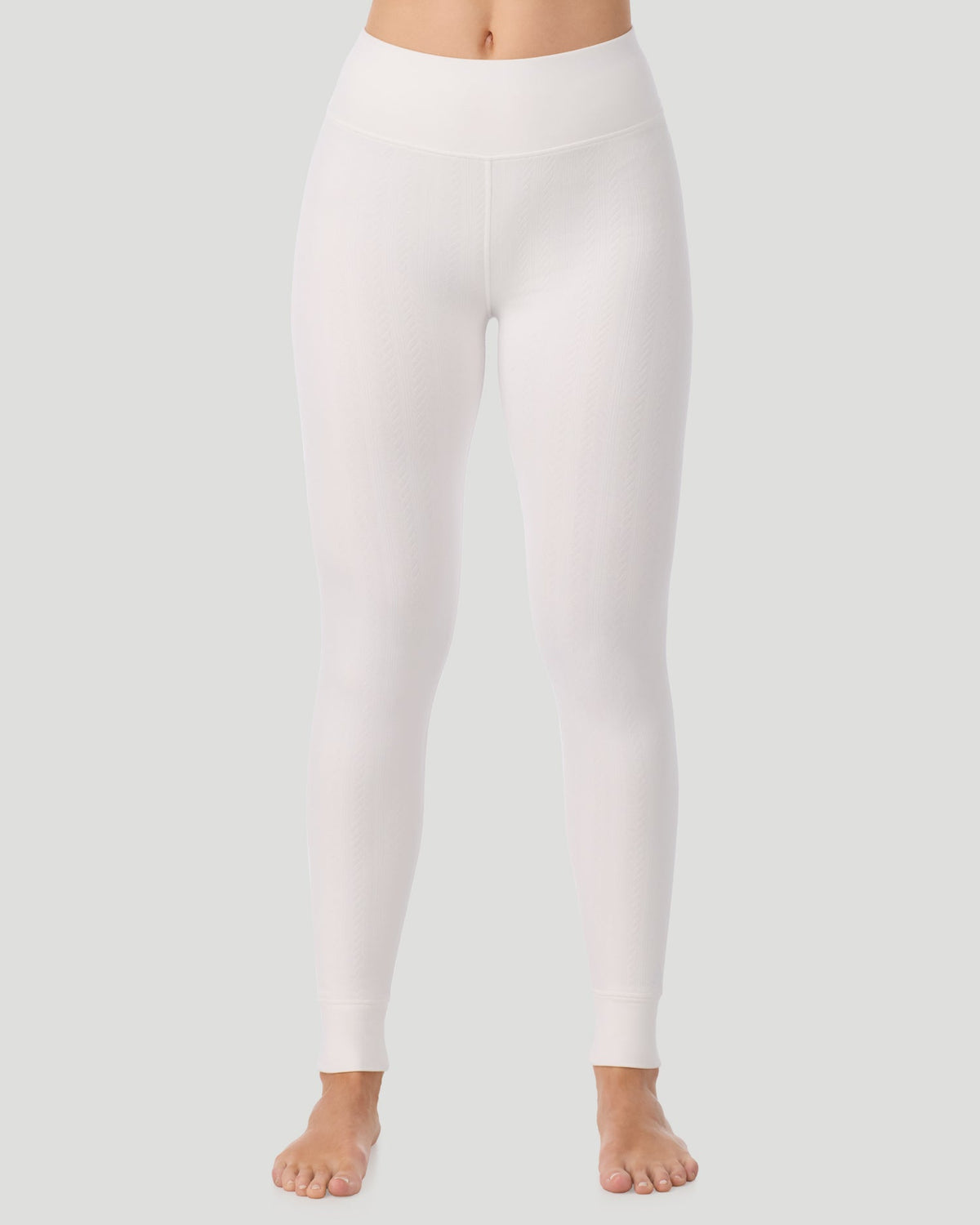 Ivory; Model is wearing a size S. She is 5’11.5”, Bust 34”, Waist 27”, Hips 38.5”. @ A lady wearing Cozy Cable Legging in ivory posing front view standing shot