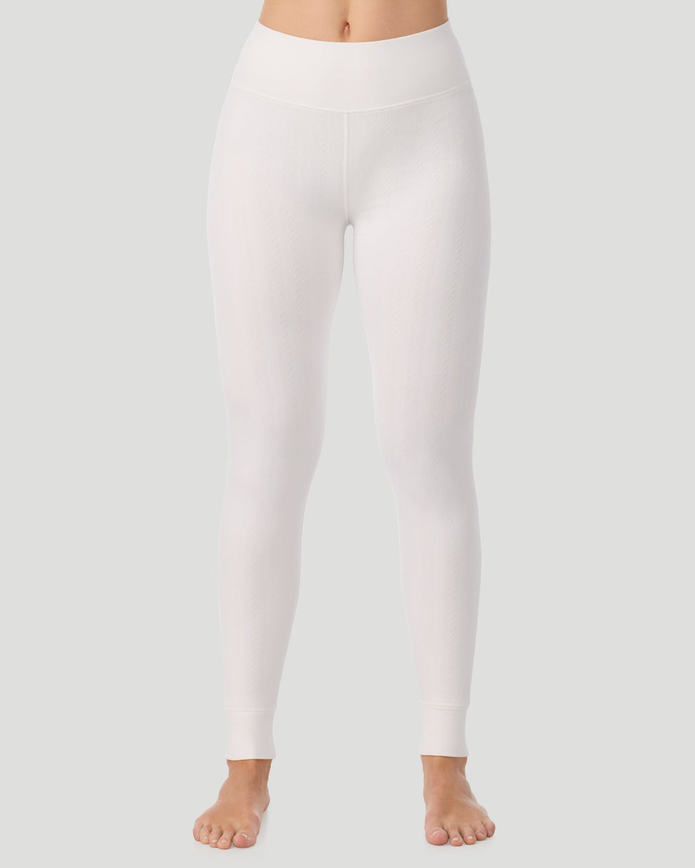 A lady wearing Cozy Cable Legging in ivory posing front view standing shot