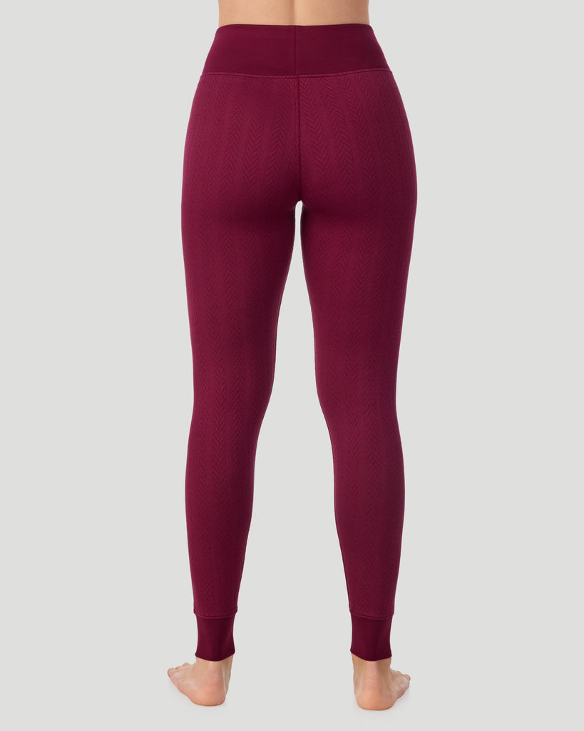  A lady wearing Cozy Cable Legging in bordeaux posing back view standing shot