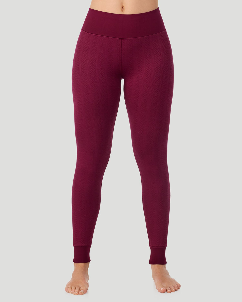 A lady wearing Cozy Cable Legging in bordeaux posing front view standing shot