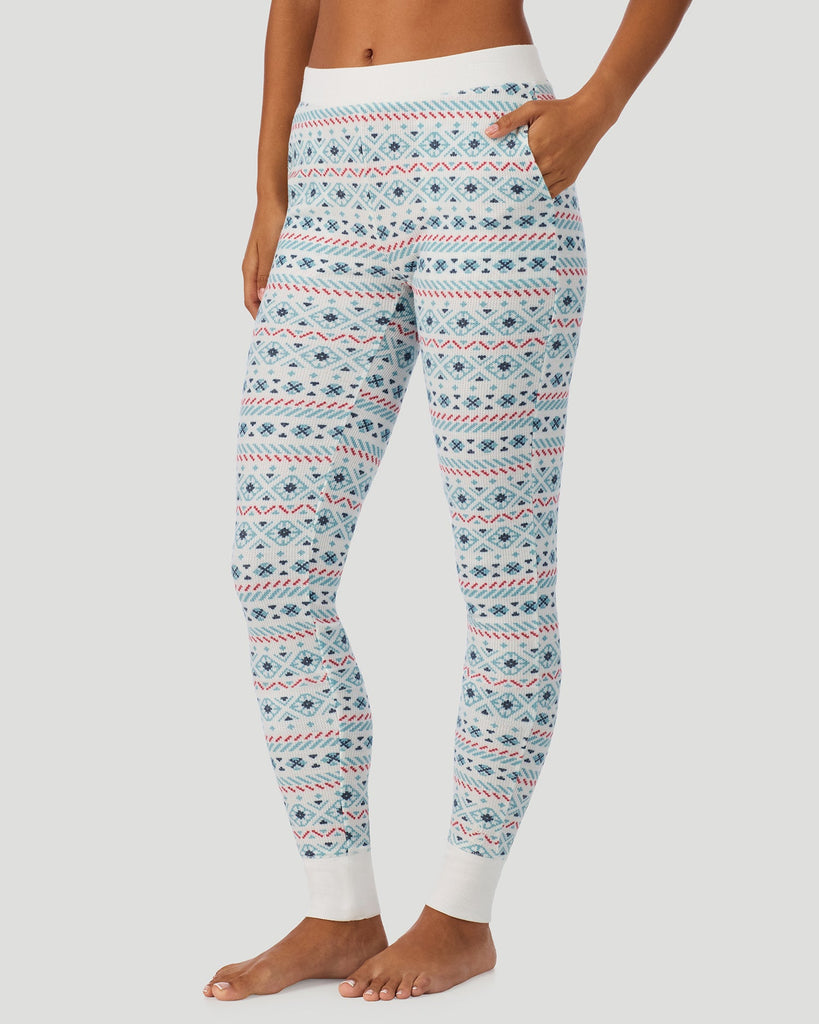  A lady wearing Ivory /Blue Fairisle Cozy Stretch Thermal Legging in a side view pose