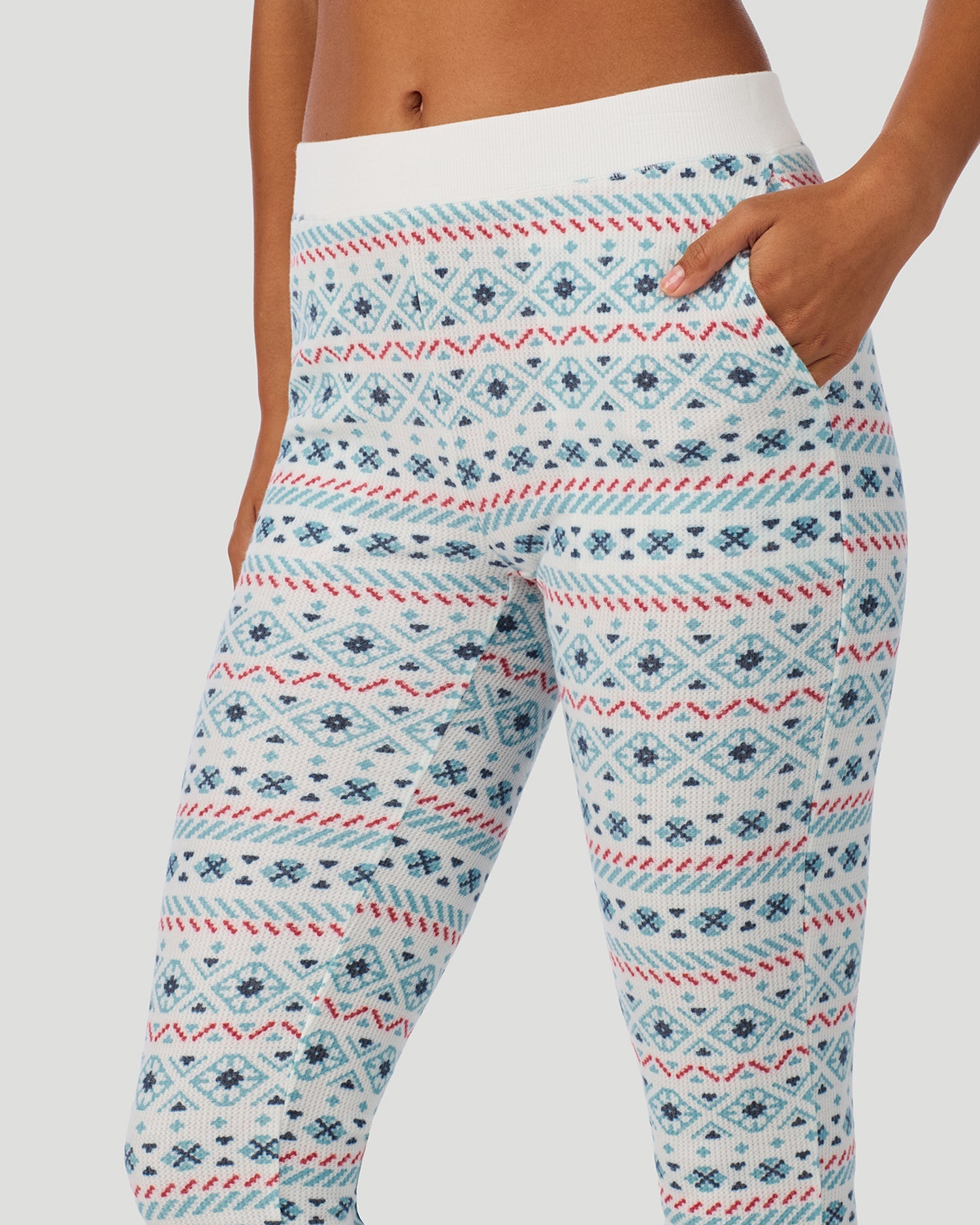 A lady wearing Cozy Stretch Thermal Legging in Ivory /Blue Fairisle