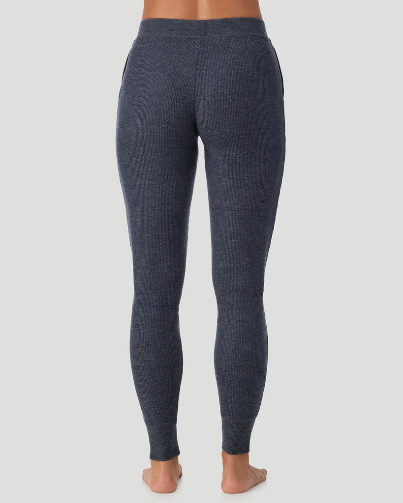  A lady wearing Medieval Blue Heather Cozy Stretch Thermal Legging in a back view pose