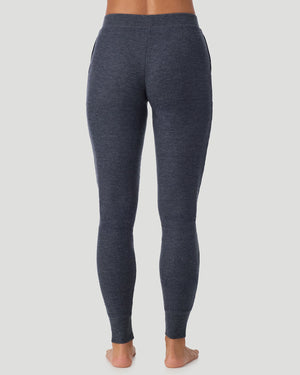  A lady wearing Medieval Blue Heather Cozy Stretch Thermal Legging in a back view pose