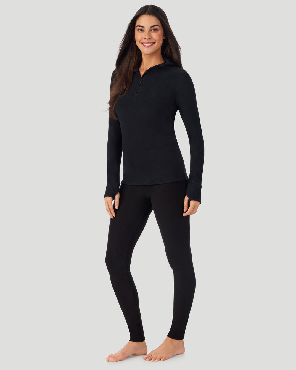 A lady wearing Black half zip hoodie one knee bent angled stance