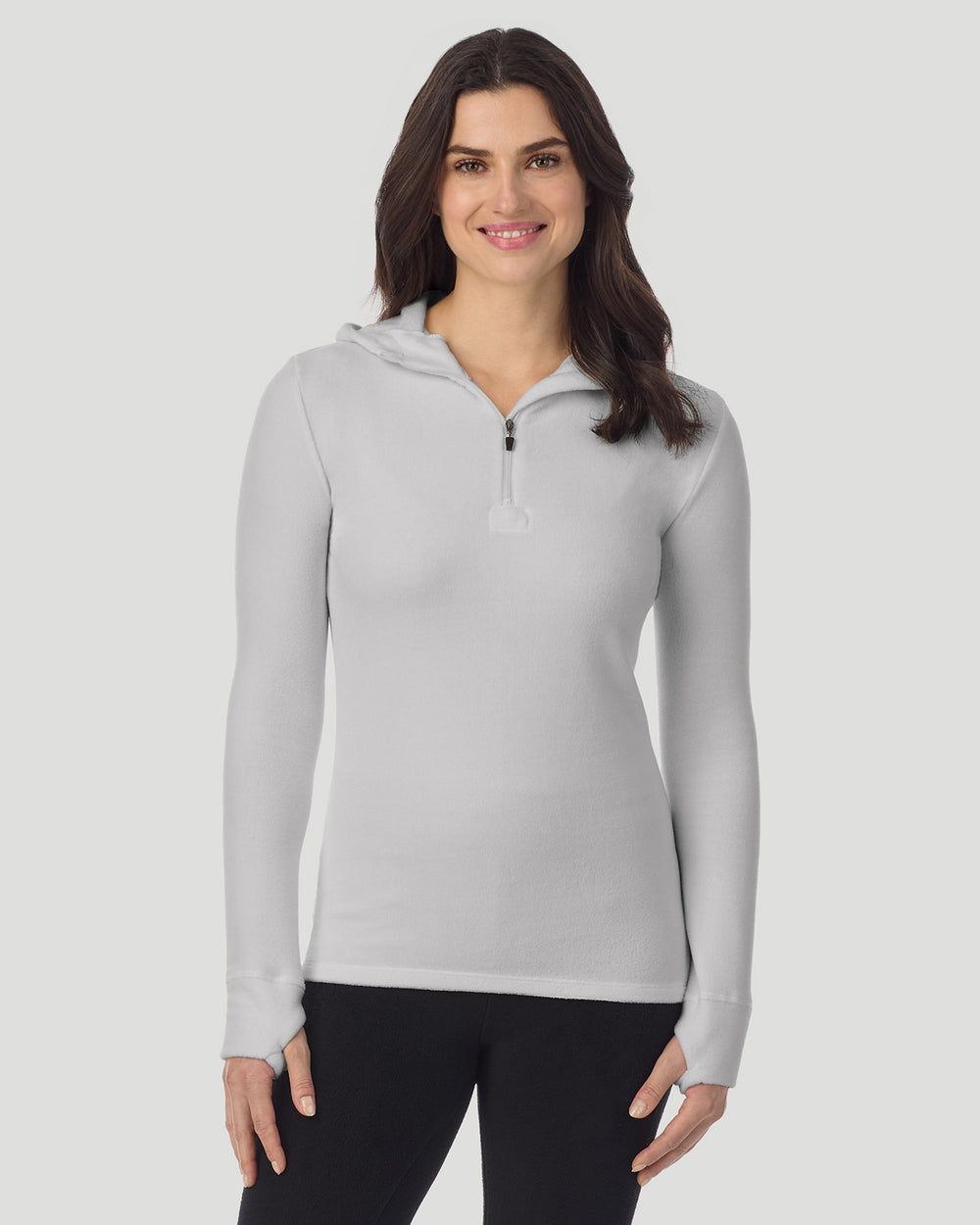 A lady wearing Light Grey Heather half zip hoodie smiling arms relaxed