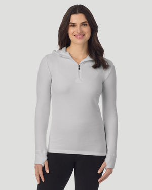  A lady wearing Light Grey Heather half zip hoodie smiling arms relaxed