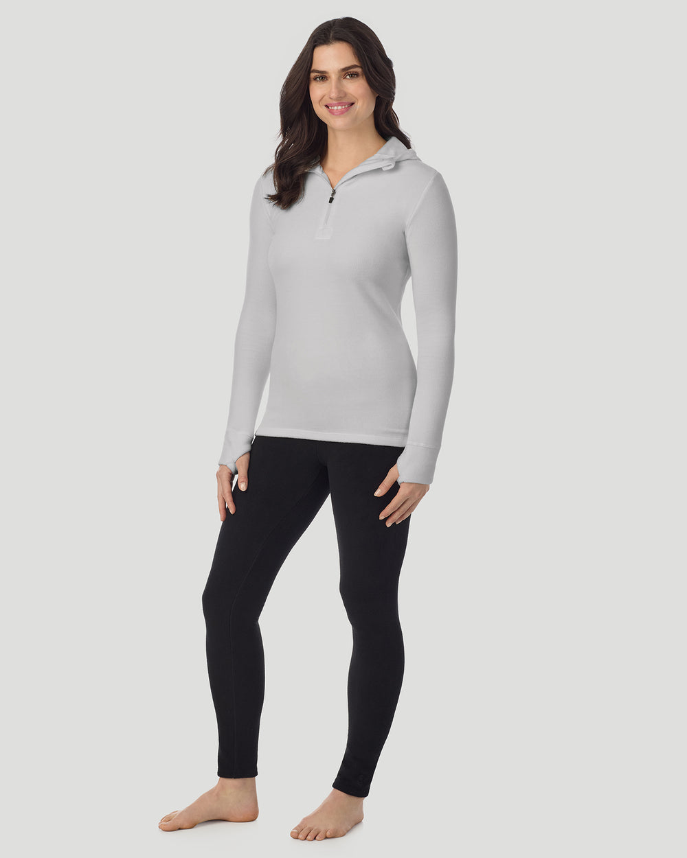 A lady wearing Light Grey Heather half zip hoodie one knee bent angled stance