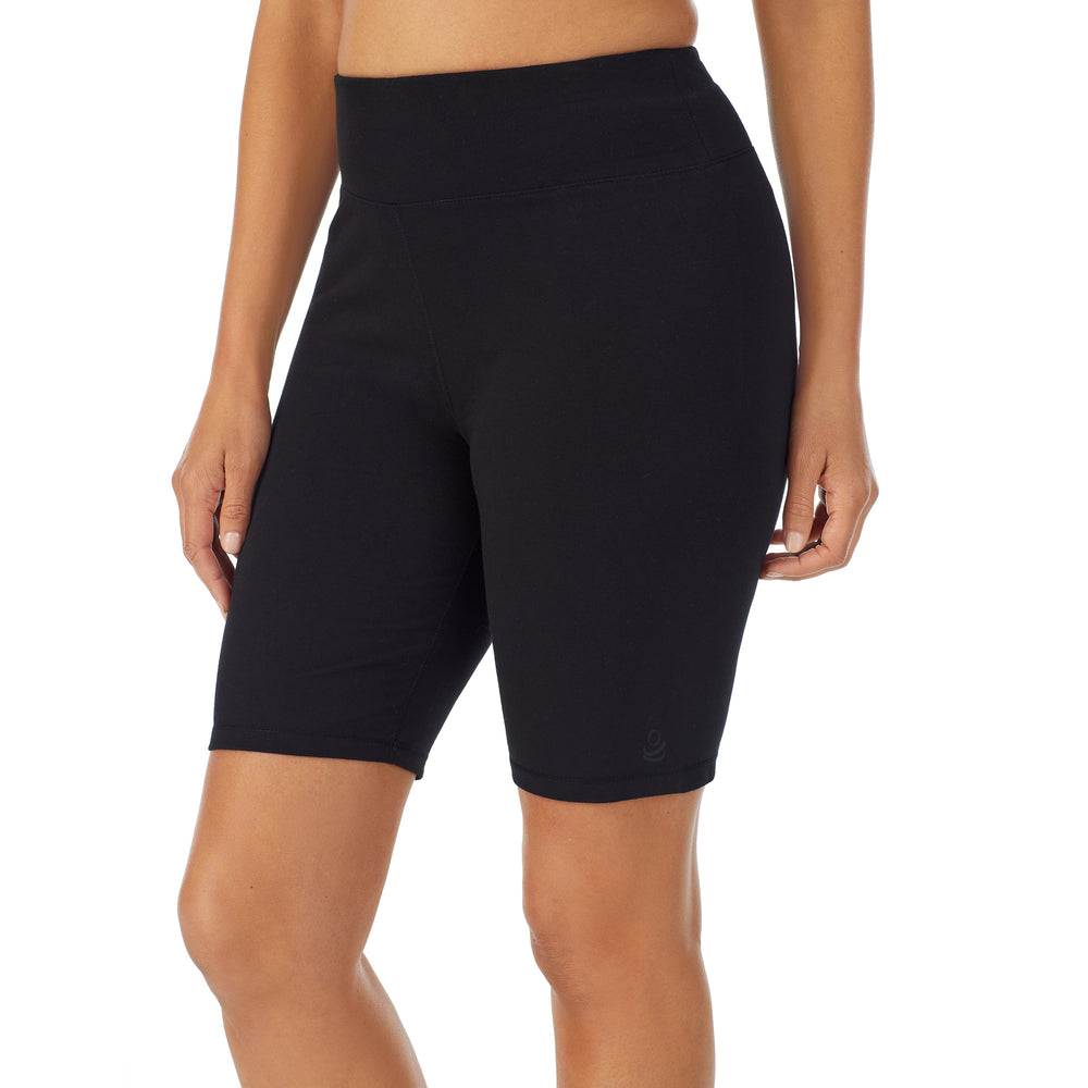 A lady wearing black cottonwear short.