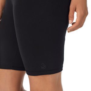 A lady wearing black cottonwear short.