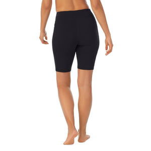 A lady wearing black cottonwear short.