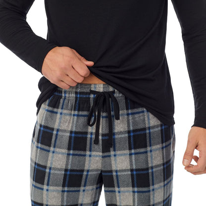 Grey Plaid; Model is wearing a size M. He is 6’2”, Waist is 32”, Inseam 34” @A Man is wearing Grey Plaid Mens Cabin Fleece Long Sleeve Crew and Pajama Pant 2-Pc Set