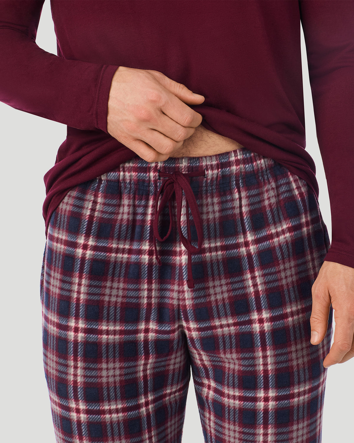 A Man is wearing Red/Red Navy Plaid Mens Cabin Fleece Long Sleeve Crew and Pajama Pant 2-Pc Set in a front view detail close up look