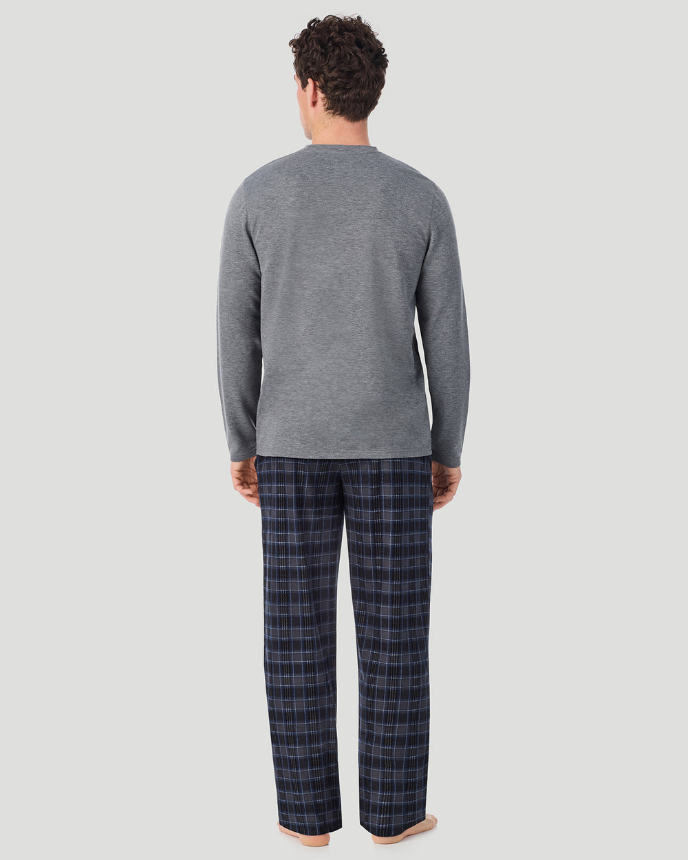 A Man is wearing Grey/Grey Multi Plaid Mens Cozy Lodge Long Sleeve Crew and Pajama Pant 2-Pc Set in a back view standing pose