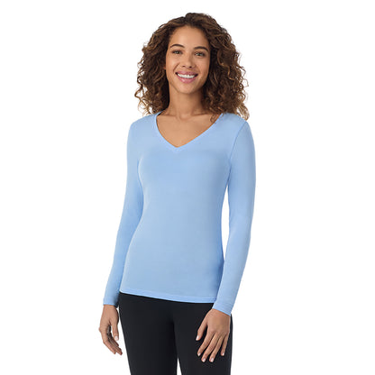 Vista Blue; Model is wearing size S. She is 5’9”, Bust 34”, Waist 23”, Hips 35”.@A lady wearing vista blue long sleeve  softwear with stretch v-neck.