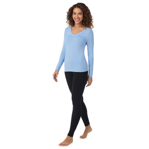 A lady wearing vista blue long sleeve  softwear with stretch v-neck.