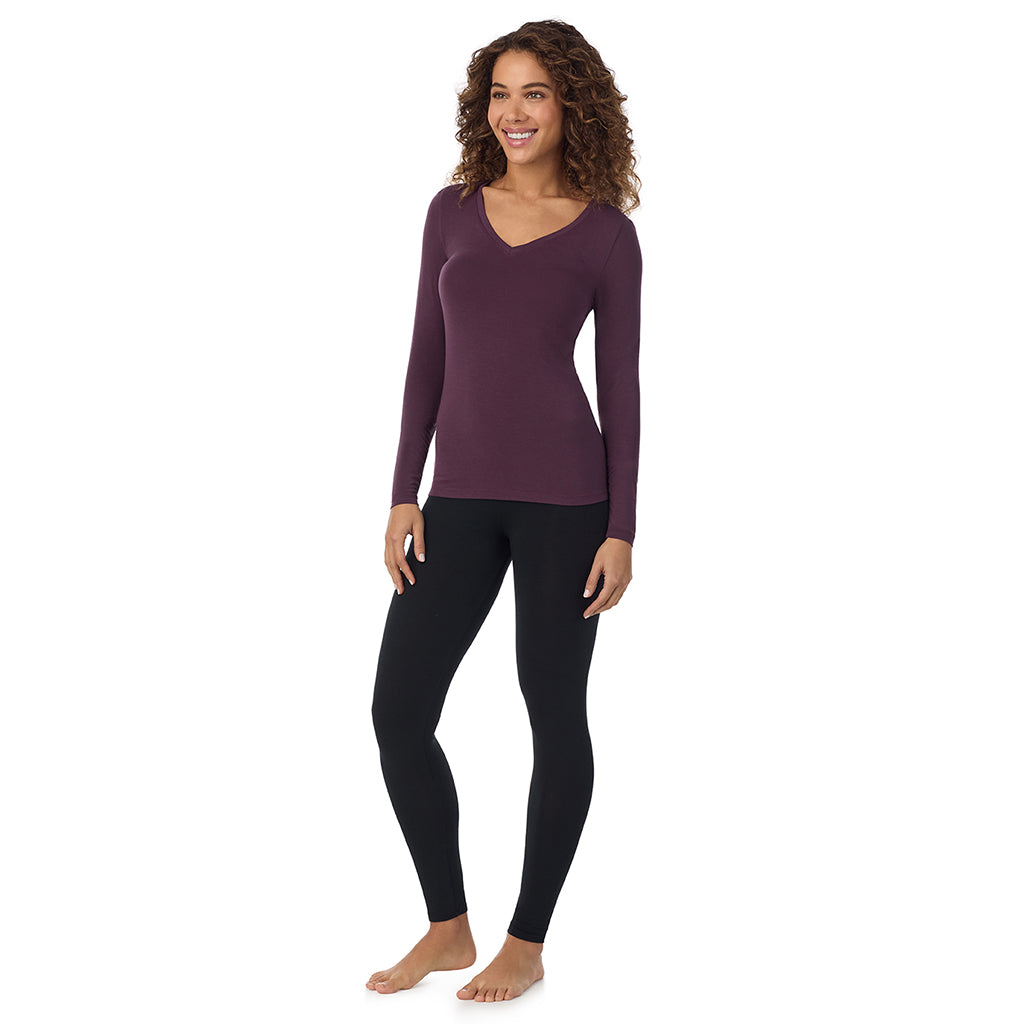 A lady wearing boysenberrye long sleeve  softwear with stretch v-neck.