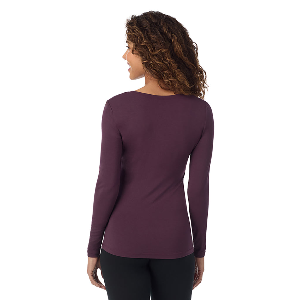 A lady wearing boysenberrye long sleeve  softwear with stretch v-neck.