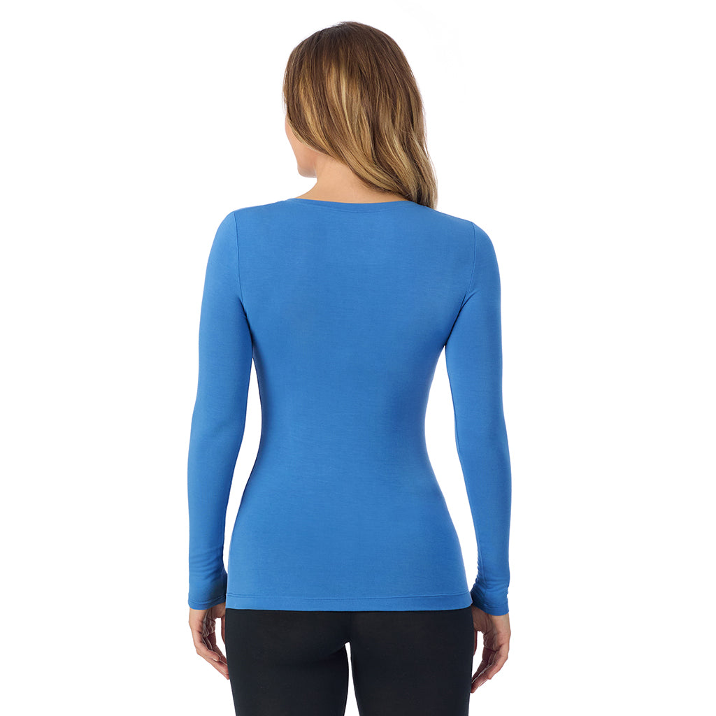 A lady wearing blue comet long sleeve  softwear with stretch v-neck.
