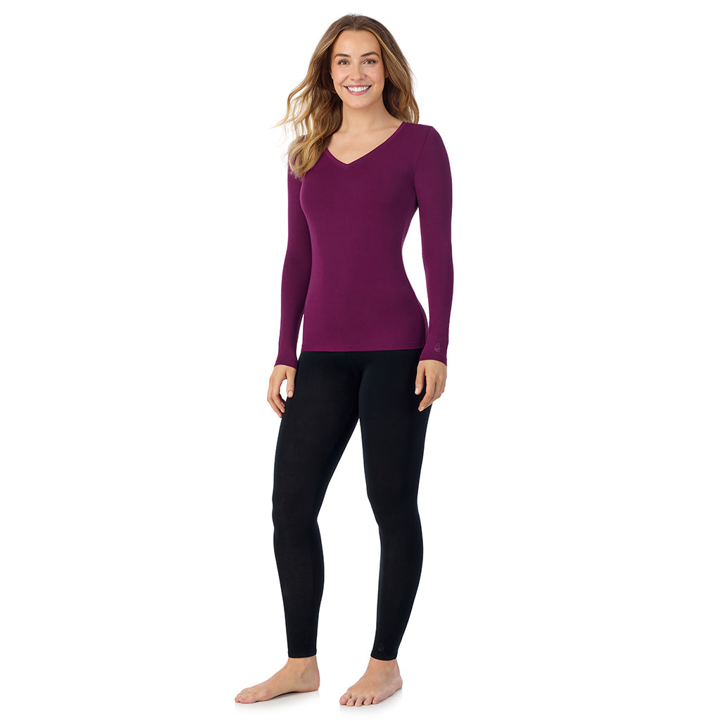 A lady wearing dark purple long sleeve  softwear with stretch v-neck.