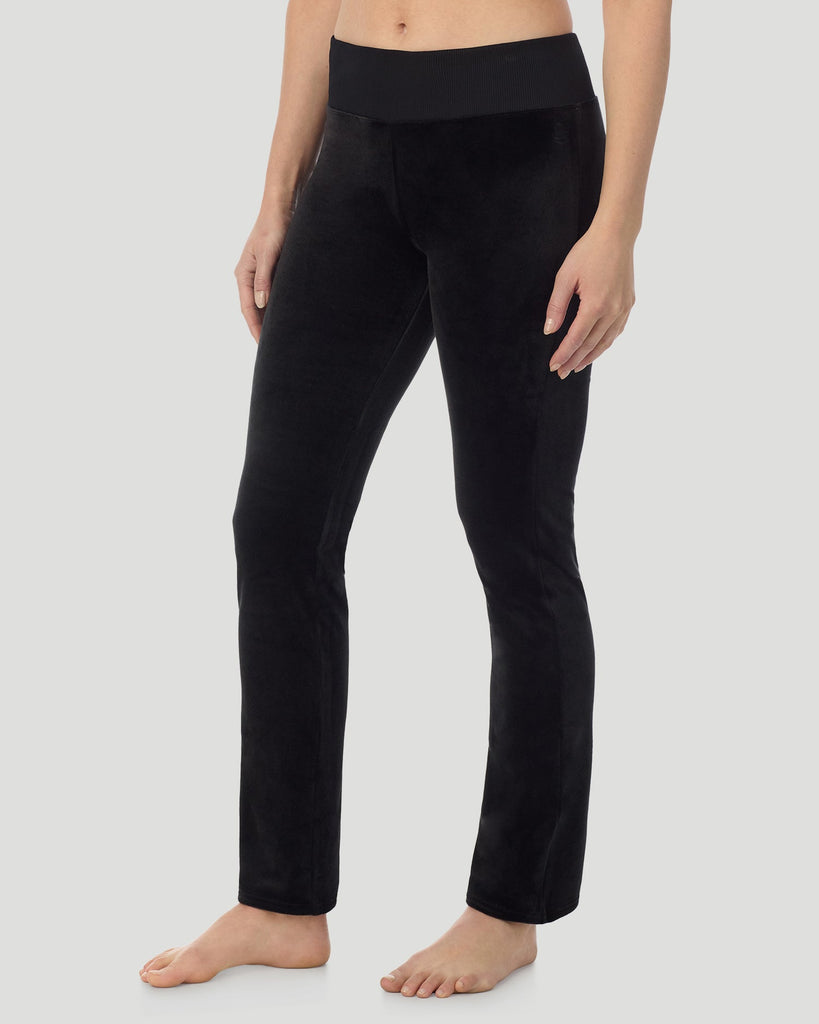 A lady wearing Stretch Velour Boot Cut Legging With Pockets in black shown in a front view side angle pose
