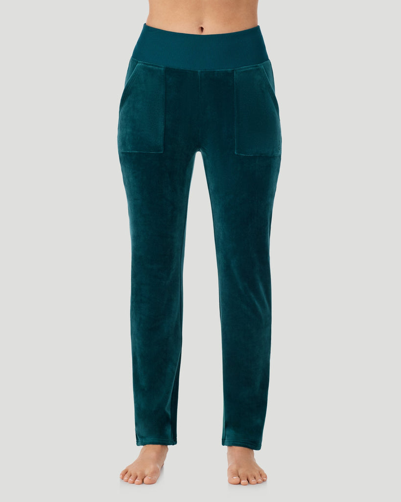 A lady wearing Stretch Velour Boot Cut Legging With Pockets in deep emerald shown in a front view pose