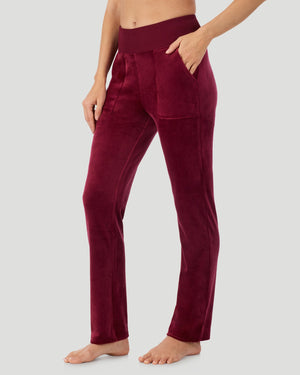 A lady wearing Stretch Velour Boot Cut Legging With Pockets in bordeaux shown in a front view side angle pose