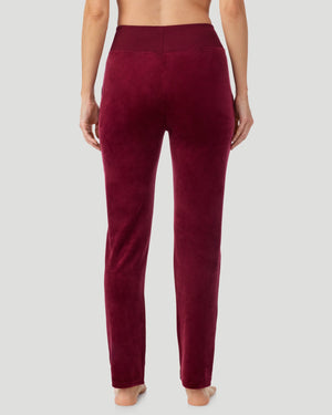 A lady wearing Stretch Velour Boot Cut Legging With Pockets in bordeaux shown in a back view pose