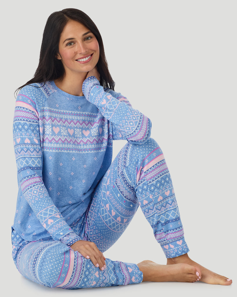  A lady wearing Peri Blue Heart Fairisle Brushed Sweater Knit Long Sleeve Jogger Pajama Set in a front view sitting pose