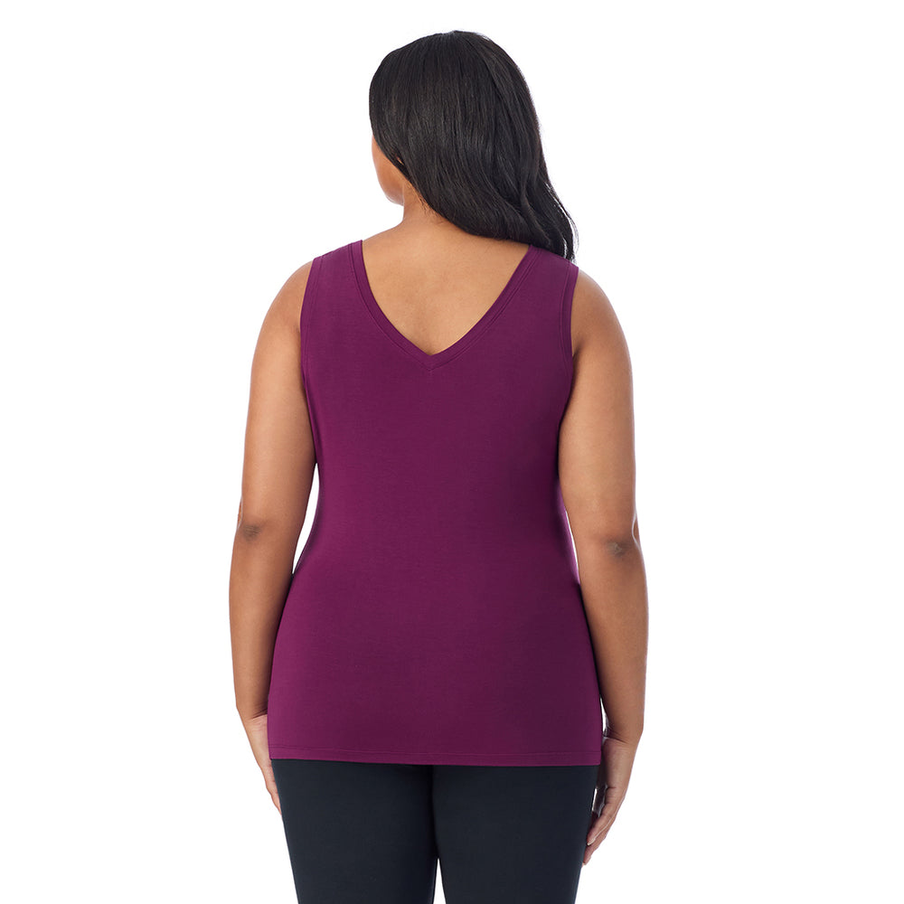 A lady wearing dark purple sleeveless reversible tank plus.