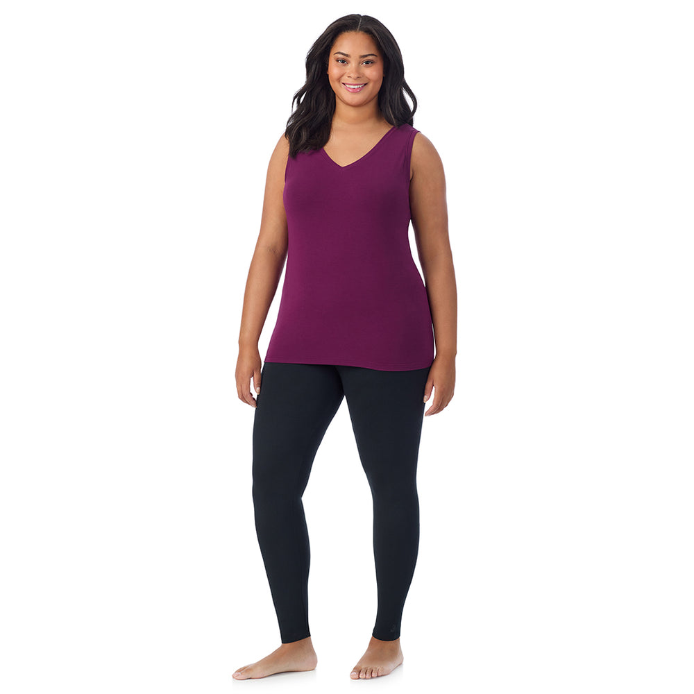 A lady wearing dark purple sleeveless reversible tank plus.