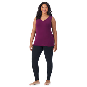 A lady wearing dark purple sleeveless reversible tank plus.
