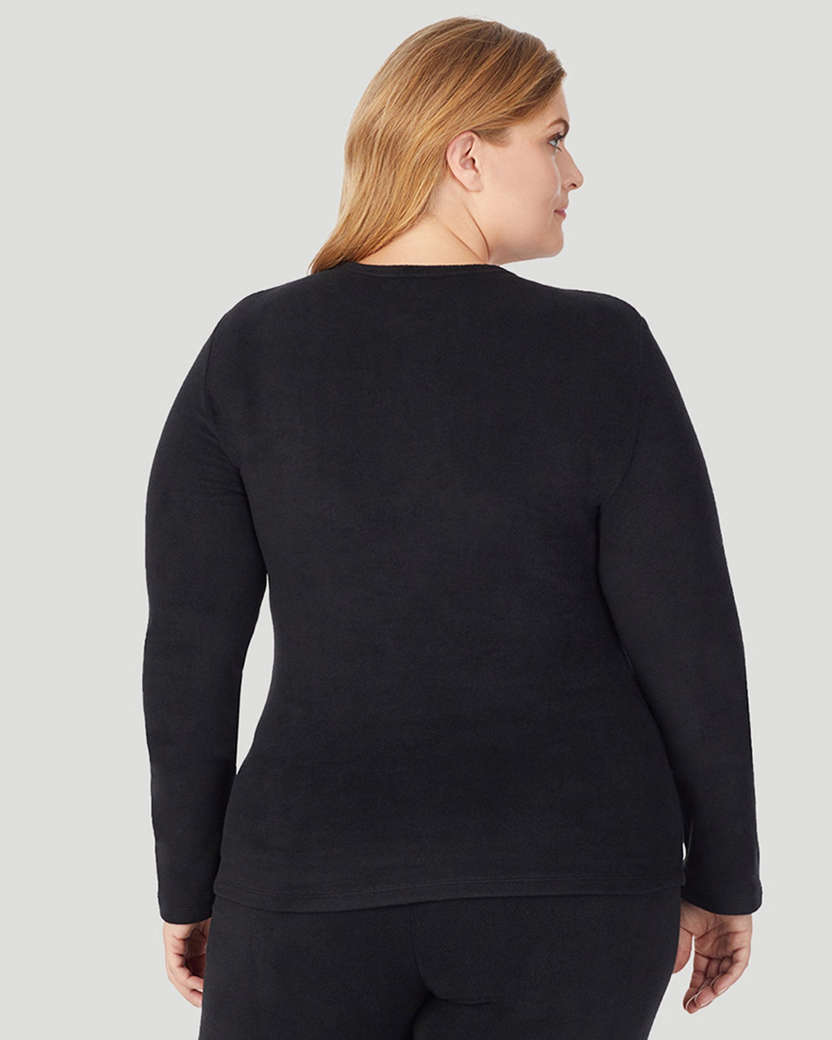 A lady wearing Fleecewear With Stretch Long Sleeve Crew PLUS in Black back view back view
