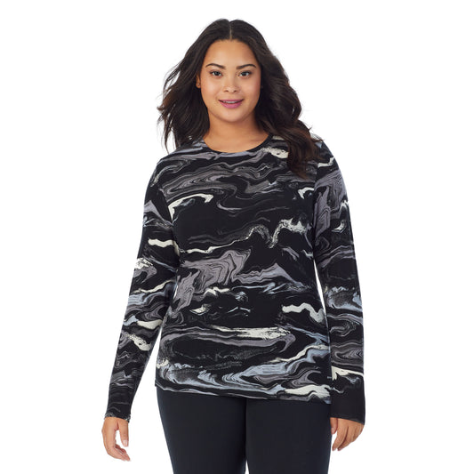 A lady wearing a black and white marble long sleeve stretch crew plus.