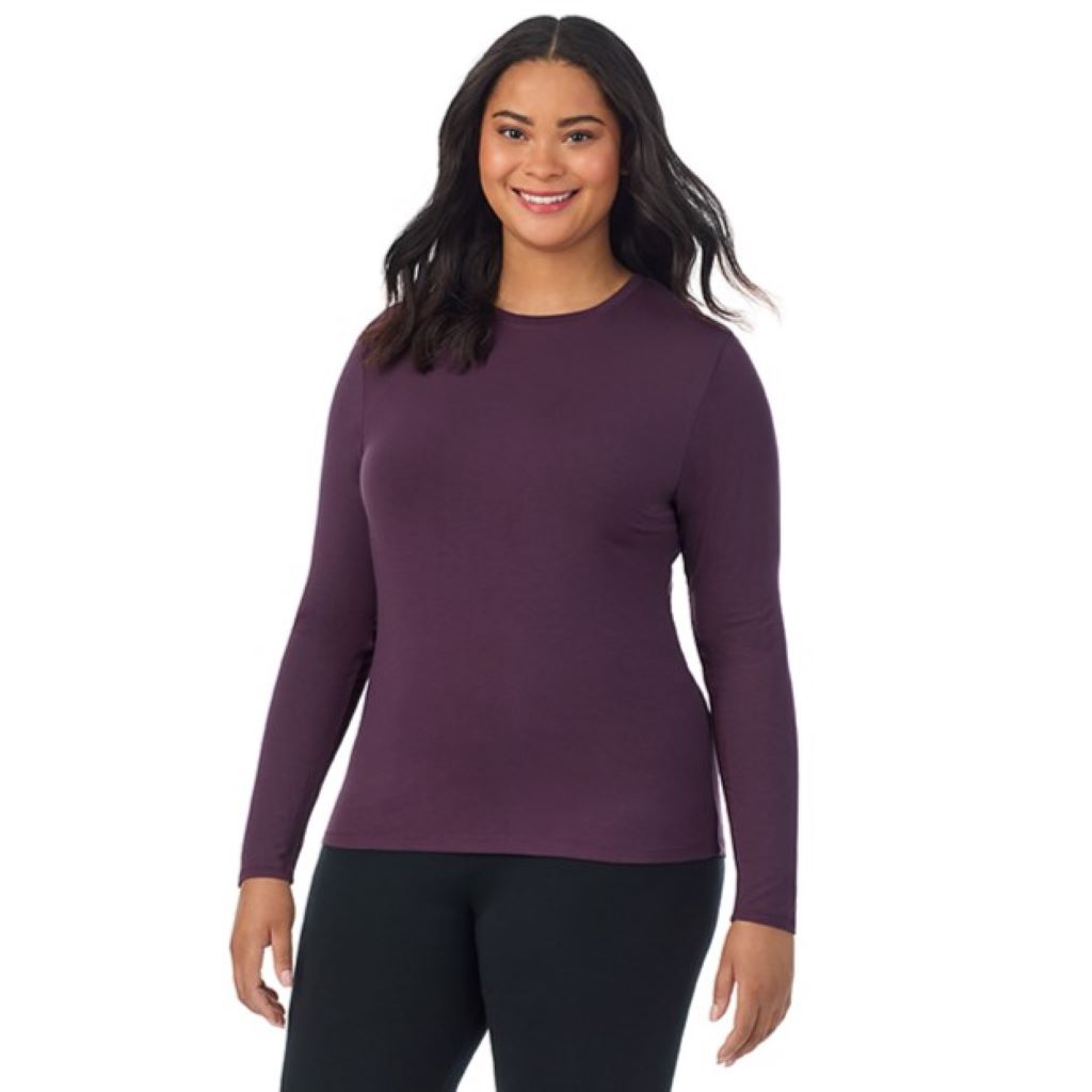 A lady wearing a boysenberry long sleeve crew plus.