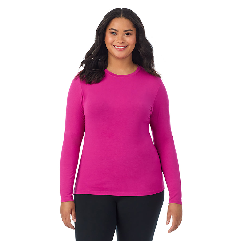 A lady wearing a deep fuschia long sleeve crew plus.